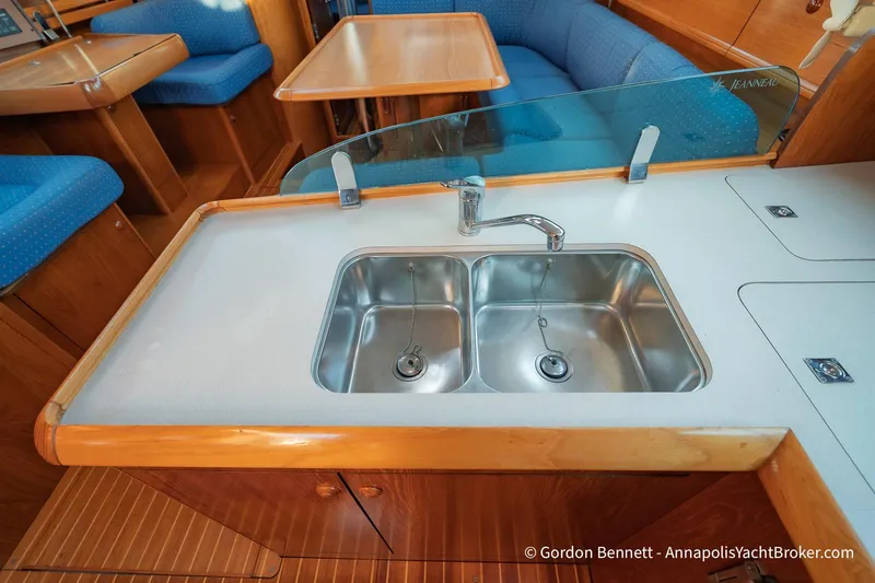 Slide: The Image of 2004 Jeanneau Sun Odyssey 43 DS yacht interior with double sink and seating area. - 36
