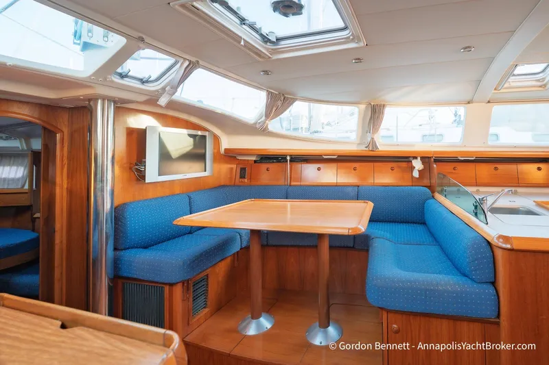 Slide: The Image of Interior of 2004 Jeanneau Sun Odyssey 43 DS yacht with blue seating and wooden table. - 39