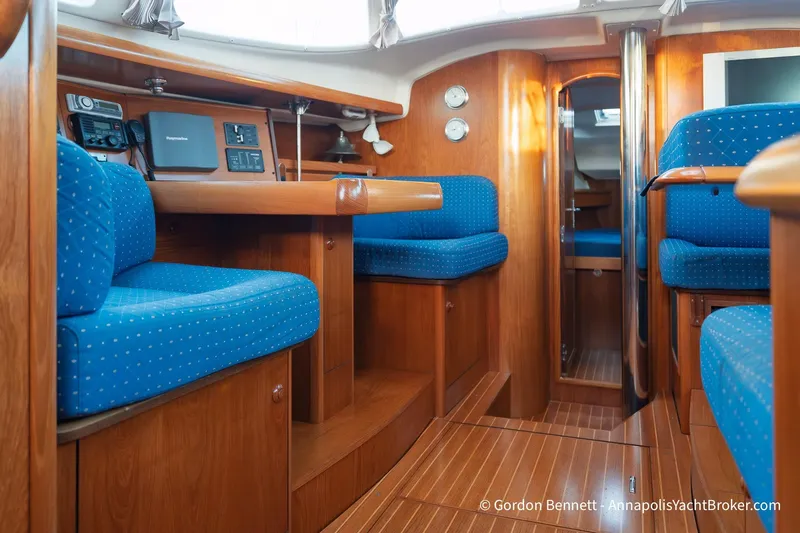 Slide: The Image of Interior of 2004 Jeanneau Sun Odyssey 43 DS yacht with blue seating and wooden finishes. - 42