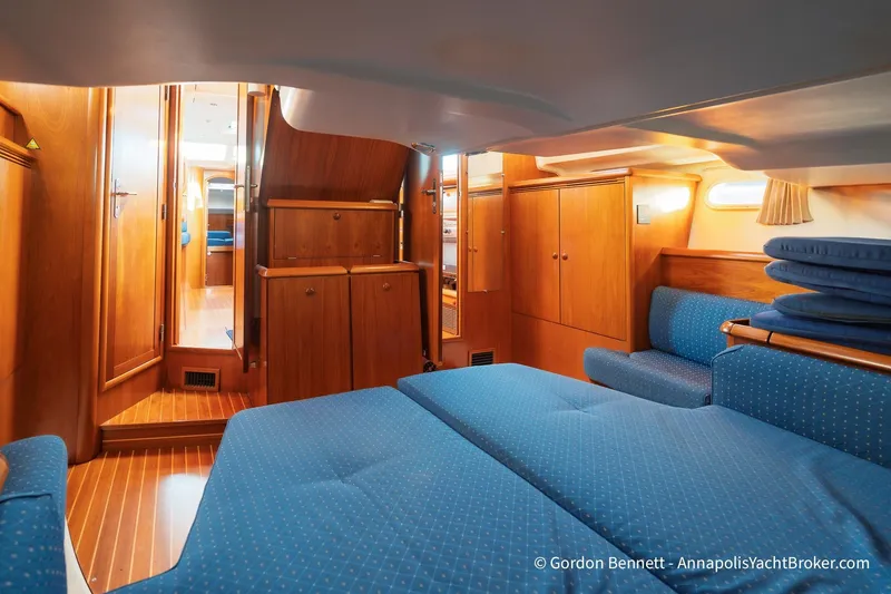 Slide: The Image of Luxurious interior of 2004 Jeanneau Sun Odyssey 43 DS yacht with wooden cabinetry and blue upholstery. - 44