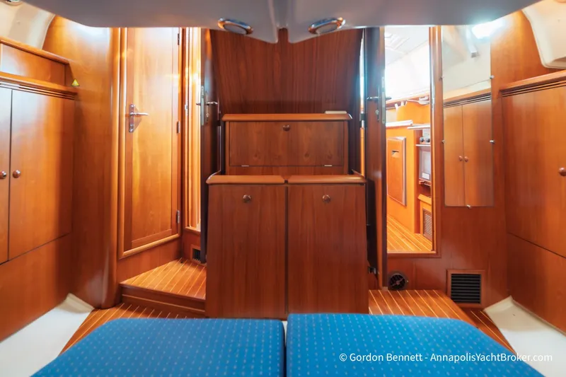 Slide: The Image of Interior of 2004 Jeanneau Sun Odyssey 43 DS yacht with wooden cabinetry and blue seating. - 45