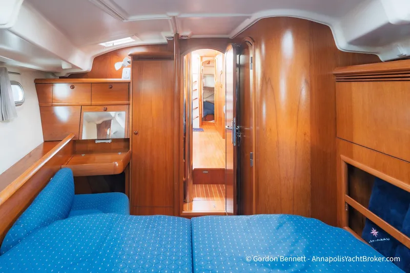 Slide: The Image of Interior of 2004 Jeanneau Sun Odyssey 43 DS yacht with wood finish and blue upholstery. - 48
