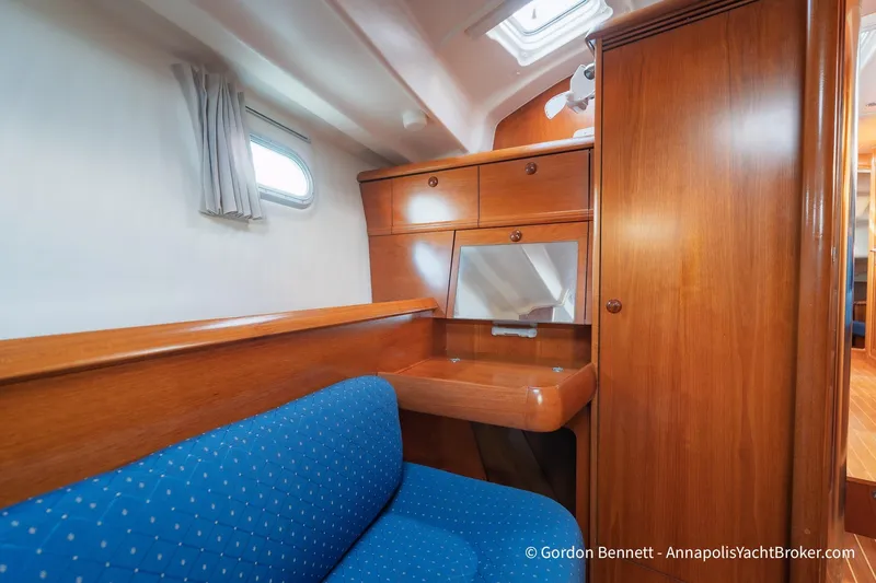 Slide: The Image of Interior of 2004 Jeanneau Sun Odyssey 43 DS yacht with wooden cabinetry and blue seating. - 49