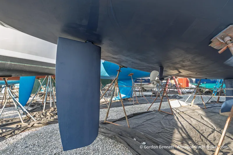 Slide: The Image of 2004 Jeanneau Sun Odyssey 43 DS sailboat under maintenance, showing keel and propeller. - 58