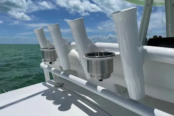 Slide: The Image of 2021 Regulator 34 boat rod holders and cup holders against ocean backdrop. - 17