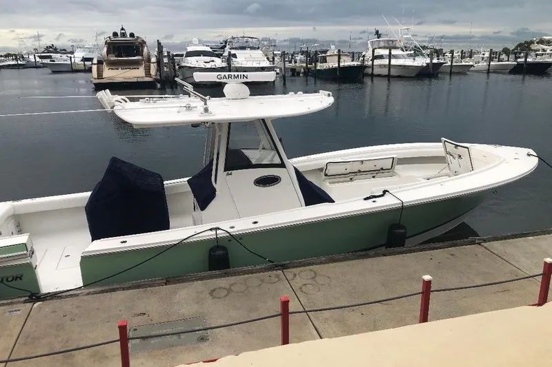 Slide: The Image of 2021 Regulator 34 boat docked at marina with overcast sky. - 5