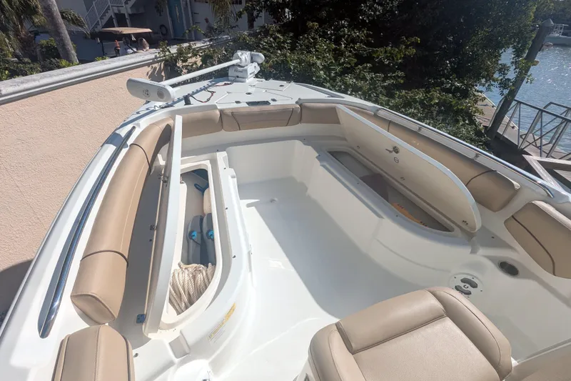 Slide: The Image of 2020 NauticStar 251 Hybrid boat interior with tan seating and storage compartments. - 11
