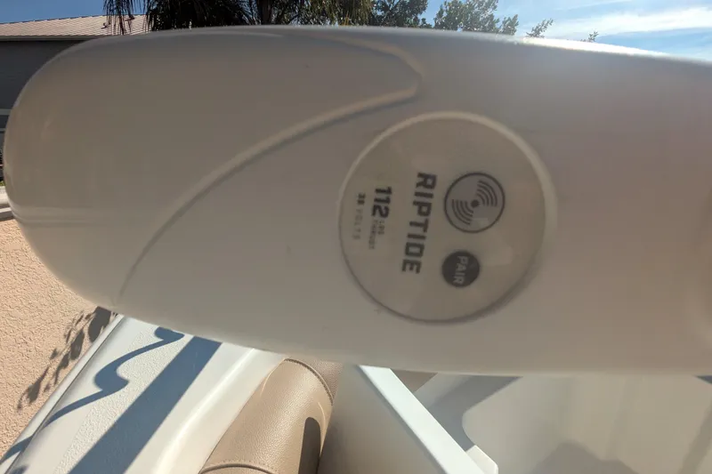 Slide: The Image of Close-up of Riptide 112 motor on 2020 NauticStar 251 Hybrid boat. - 12