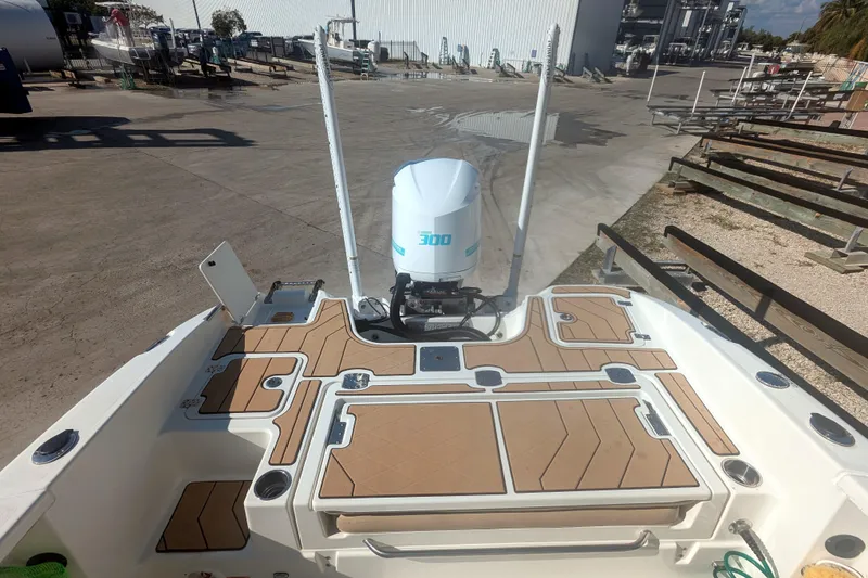 Slide: The Image of 2020 NauticStar 251 Hybrid boat with powerful outboard motor, docked in a marina. - 14