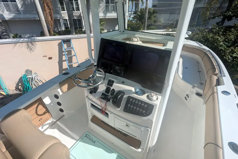Slide: The Image of 2020 NauticStar 251 Hybrid boat interior with steering console and seating. - 4