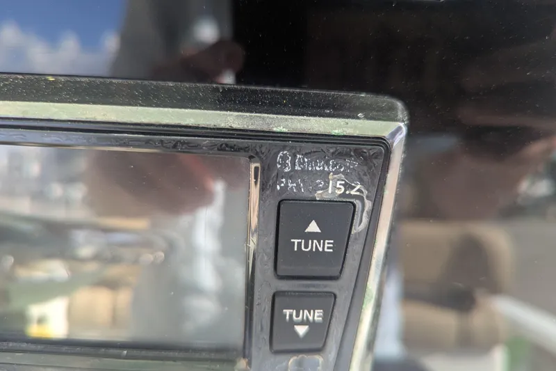 Slide: The Image of Close-up of a NauticStar 251 Hybrid 2020 boat control panel with tune buttons. - 7