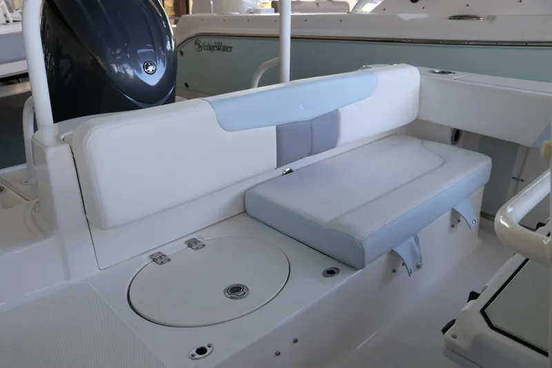 Slide: The Image of 2026 Robalo R202 Explorer boat interior with cushioned seating and storage compartment. - 11