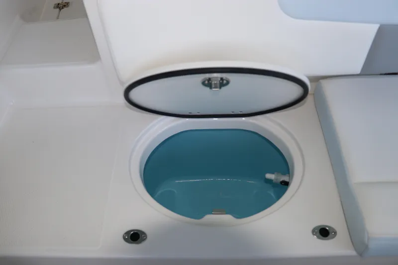 Slide: The Image of 2026 Robalo R202 Explorer boat storage compartment with open lid. - 12