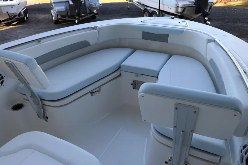 Slide: The Image of 2026 Robalo R202 Explorer boat interior with cushioned seating and storage compartments. - 31