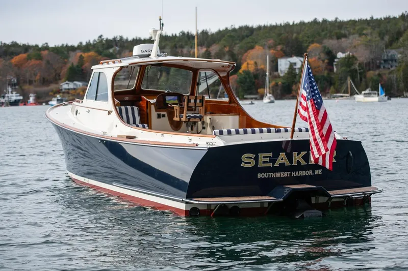 Slide: The Image of 2001 Hinckley Picnic Boat Classic on water, American flag, Southwest Harbor, Maine. - 12