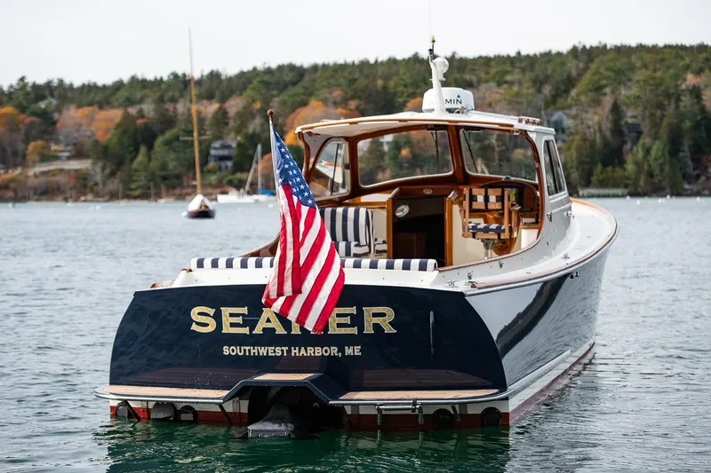 Slide: The Image of 2001 Hinckley Picnic Boat Classic on water, displaying American flag, Southwest Harbor, ME. - 14