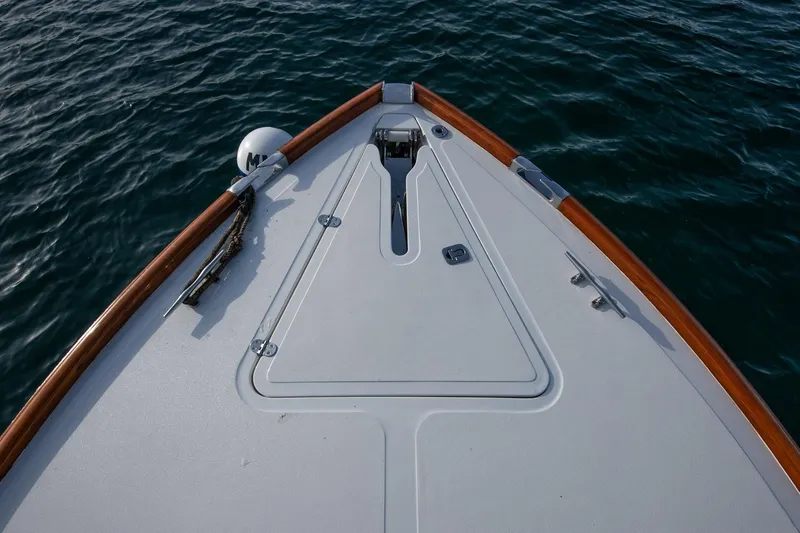 Slide: The Image of Bow of 2001 Hinckley Picnic Boat Classic on calm water. - 25