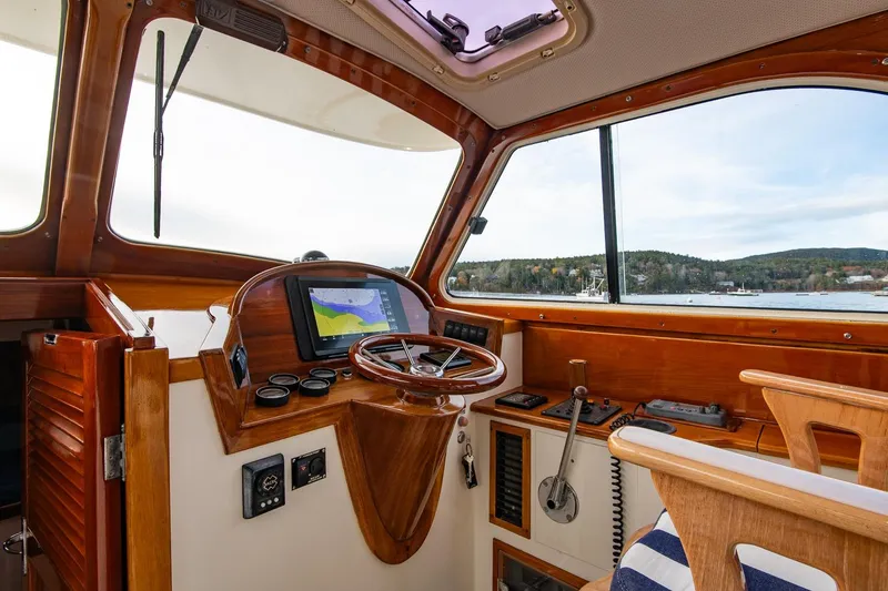 Slide: The Image of 2001 Hinckley Picnic Boat Classic helm with wooden accents and navigation equipment. - 34