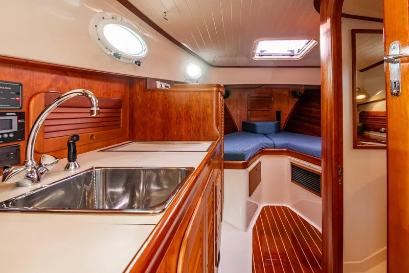Slide: The Image of Interior of 2001 Hinckley Picnic Boat Classic with wood finish and compact kitchen. - 44