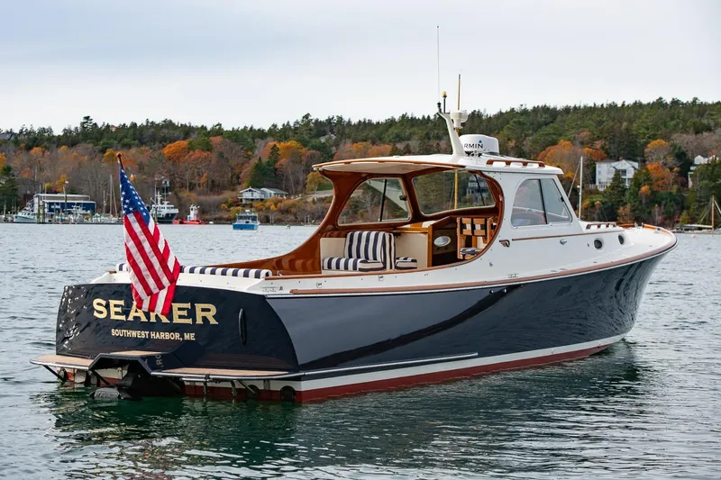 Slide: The Image of 2001 Hinckley Picnic Boat Classic on water, American flag, autumn shoreline background. - 16