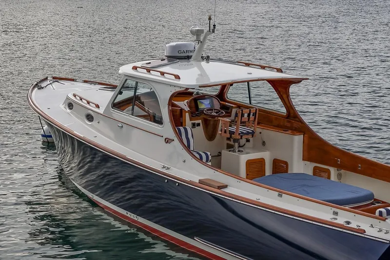 Slide: The Image of 2001 Hinckley Picnic Boat Classic on calm water, showcasing elegant design and craftsmanship. - 19