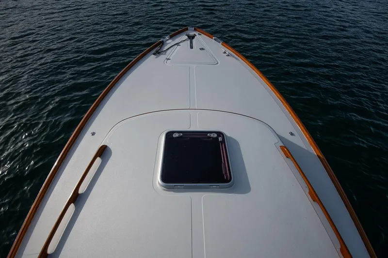 Slide: The Image of 2001 Hinckley Picnic Boat Classic bow on calm water, showcasing elegant design. - 24