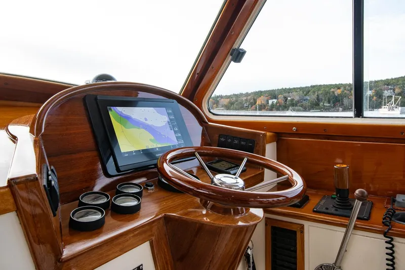 Slide: The Image of 2001 Hinckley Picnic Boat Classic helm with wooden steering wheel and navigation display. - 35