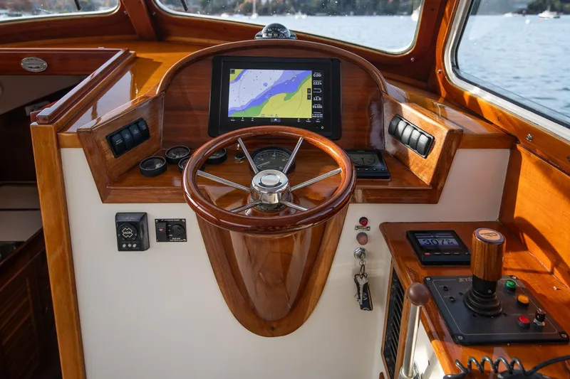 Slide: The Image of 2001 Hinckley Picnic Boat Classic helm with wooden steering wheel and navigation display. - 36