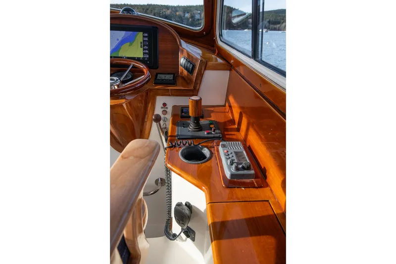 Slide: The Image of 2001 Hinckley Picnic Boat Classic helm with polished wood and navigation controls. - 37