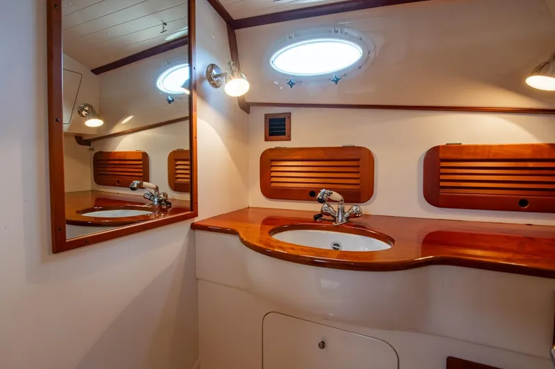 Slide: The Image of Luxurious 2001 Hinckley Picnic Boat Classic bathroom with wooden accents and elegant fixtures. - 47