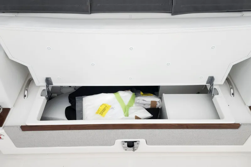 Slide: The Image of Storage compartment on a 2026 Tiara Yachts 34 LS, open with items inside. - 10