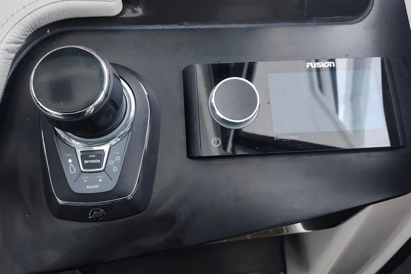 Slide: The Image of Control panel of 2026 Tiara Yachts 34 LS featuring joystick and Fusion audio system. - 18