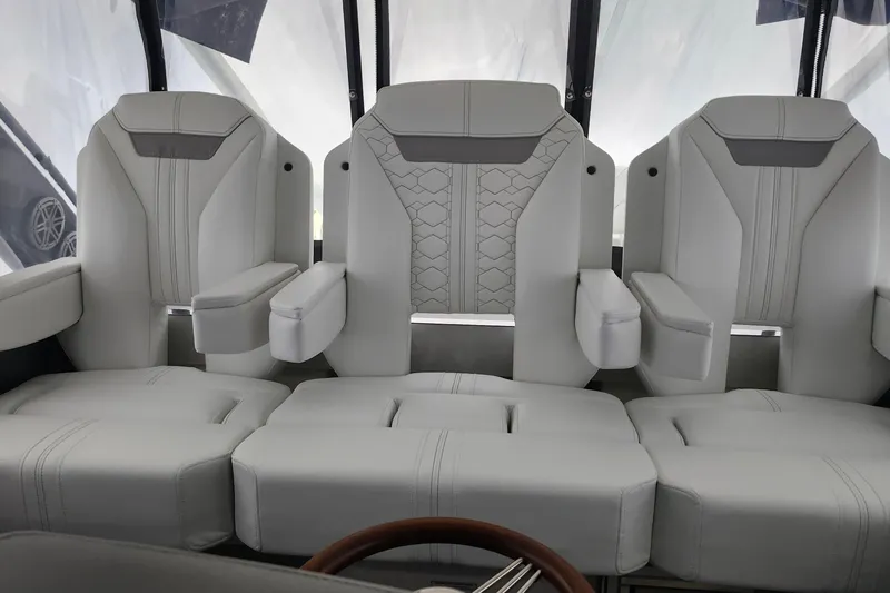 Slide: The Image of 2026 Tiara Yachts 34 LS interior seating with luxurious white upholstery. - 19