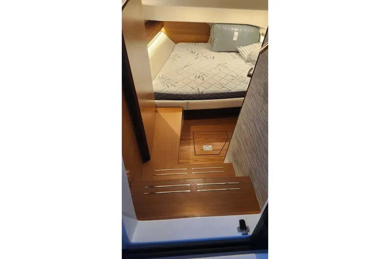 Slide: The Image of Interior of 2026 Tiara Yachts 34 LS with bed and wooden steps. - 23
