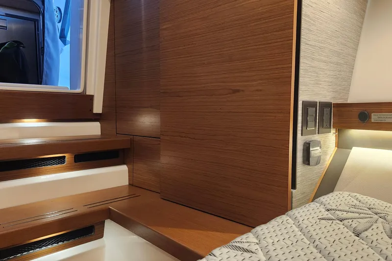 Slide: The Image of Interior of 2026 Tiara Yachts 34 LS, featuring wooden paneling and modern design elements. - 25