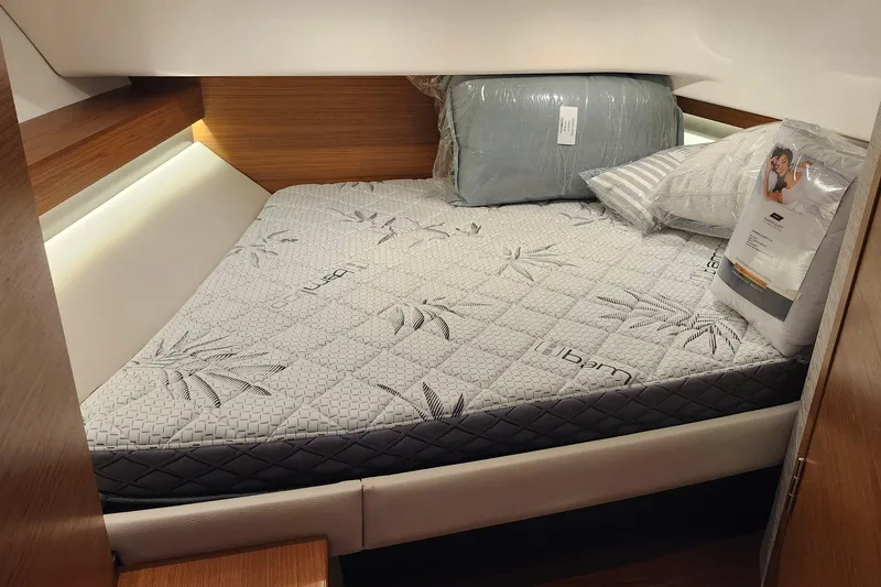 Slide: The Image of Cozy cabin bed in 2026 Tiara Yachts 34 LS, featuring plush bedding and modern design. - 26