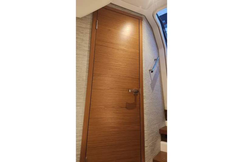 Slide: The Image of Interior view of 2026 Tiara Yachts 34 LS, featuring a sleek wooden door. - 27