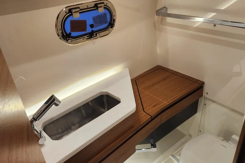 Slide: The Image of Luxurious bathroom interior of 2026 Tiara Yachts 34 LS with modern sink and wooden accents. - 30