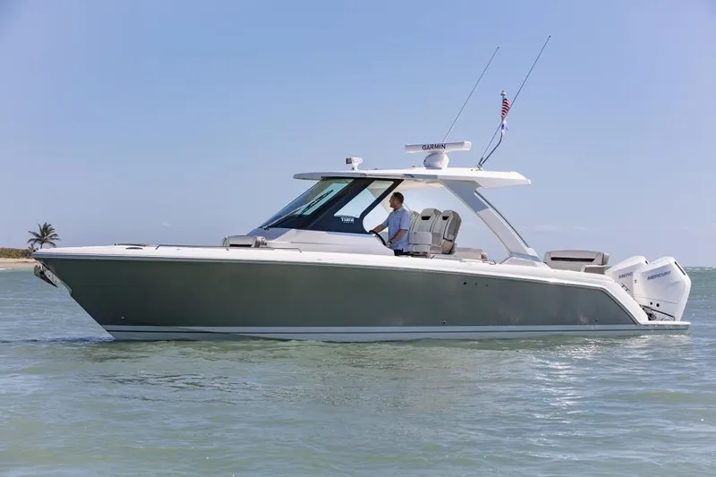 Slide: The Image of Manufacturer Provided Image: 2025 Tiara Yachts 34 LS cruising on calm waters under a clear blue sky. - 36