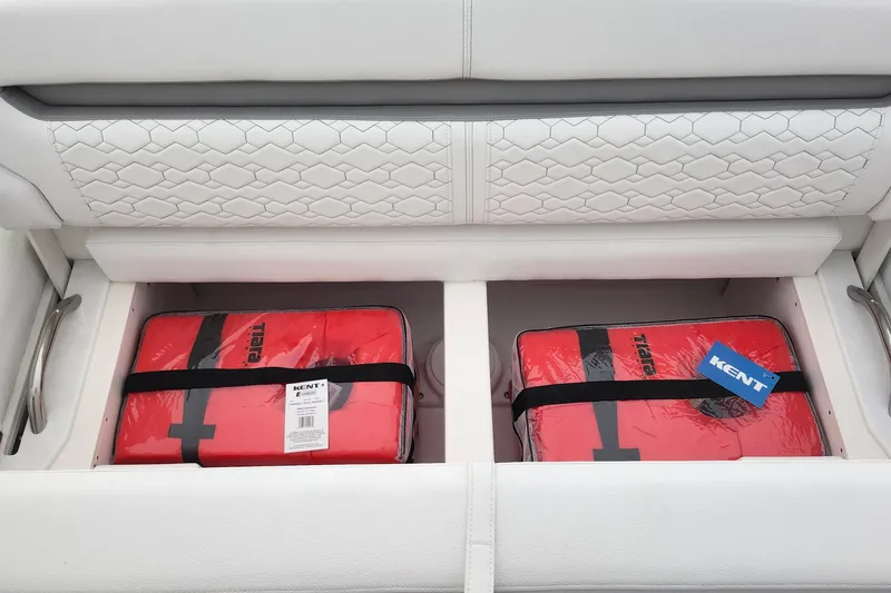 Slide: The Image of Storage compartment on 2026 Tiara Yachts 34 LS with red life jackets. - 4
