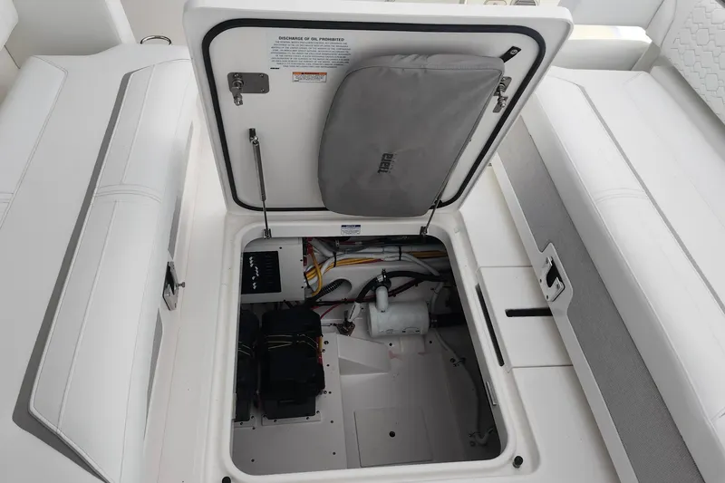 Slide: The Image of 2026 Tiara Yachts 34 LS storage compartment with open hatch, revealing interior components. - 7