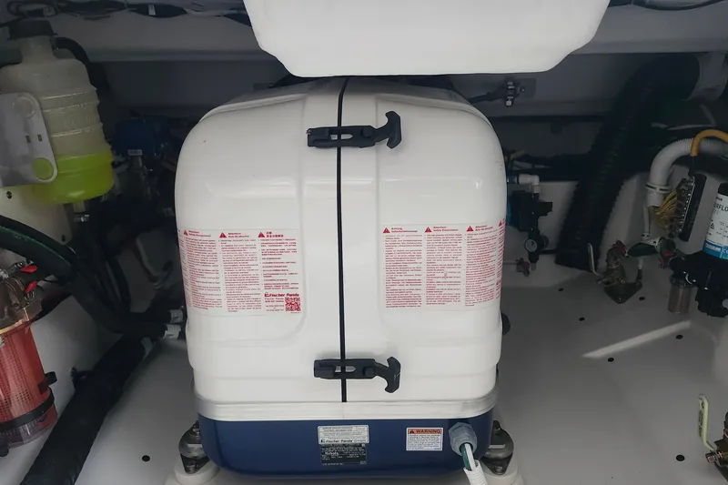 Slide: The Image of Engine compartment of 2026 Tiara Yachts 34 LS, featuring a white marine generator. - 8