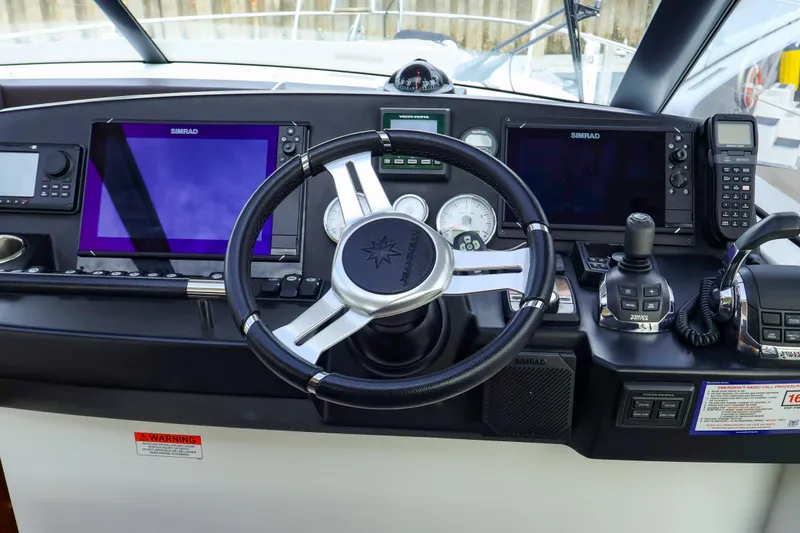 Slide: The Image of Steering console of 2015 Jeanneau NC 14 with Simrad navigation systems. - 13