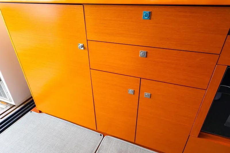 Slide: The Image of Wooden cabinetry on 2015 Jeanneau NC 14 yacht interior, featuring sleek design and modern finish. - 15