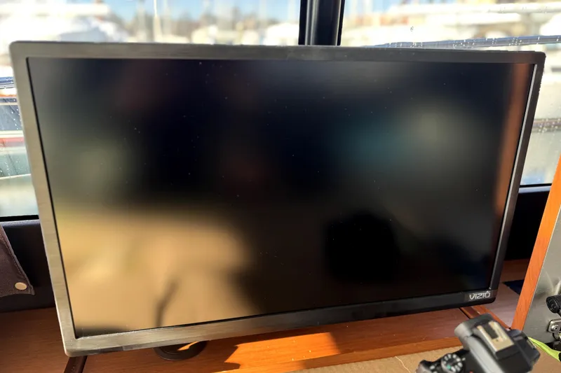 Slide: The Image of Vizio monitor inside 2015 Jeanneau NC 14 boat, with reflections on screen. - 17