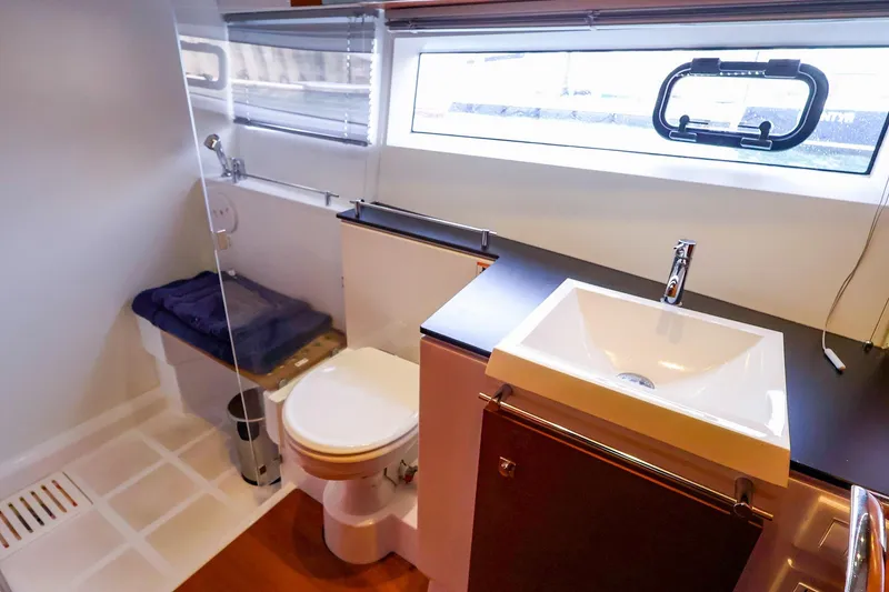 Slide: The Image of Modern bathroom in 2015 Jeanneau NC 14 yacht with sink, toilet, and shower. - 25