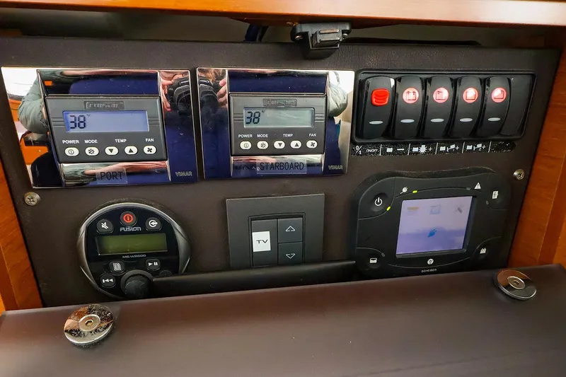 Slide: The Image of Control panel of 2015 Jeanneau NC 14 boat with digital displays and switches. - 27