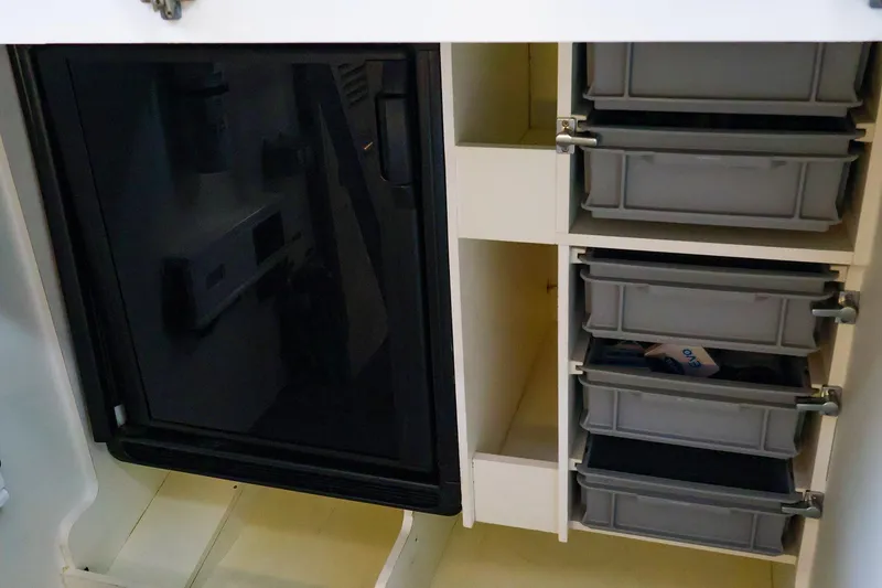 Slide: The Image of Interior storage of 2015 Jeanneau NC 14 boat with organized compartments and drawers. - 31