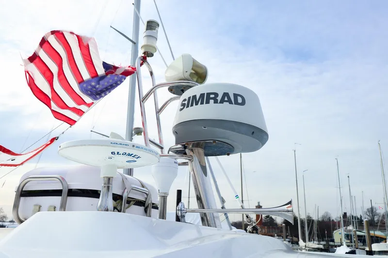 Slide: The Image of 2015 Jeanneau NC 14 boat with Simrad radar and American flag in marina. - 4