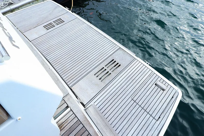 Slide: The Image of 2015 Jeanneau NC 14 swim platform with teak decking by the water. - 5